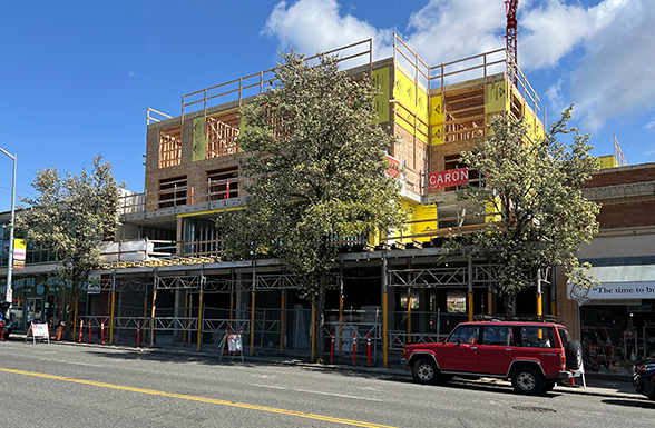 A street view of the now under construction Seattle multi-family residential housing project the Seattle California Avenue development, designed by Pacific Northwest architects AXIS/GFA Architecture + Design.